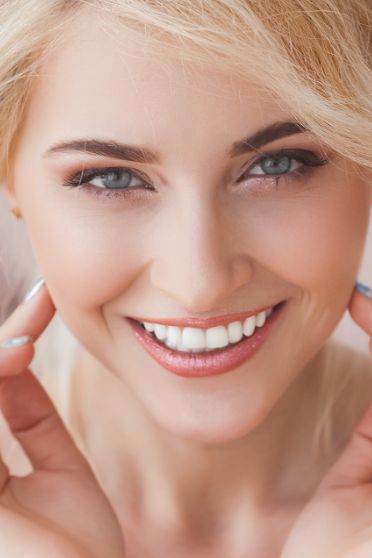 Young blonde woman grinning